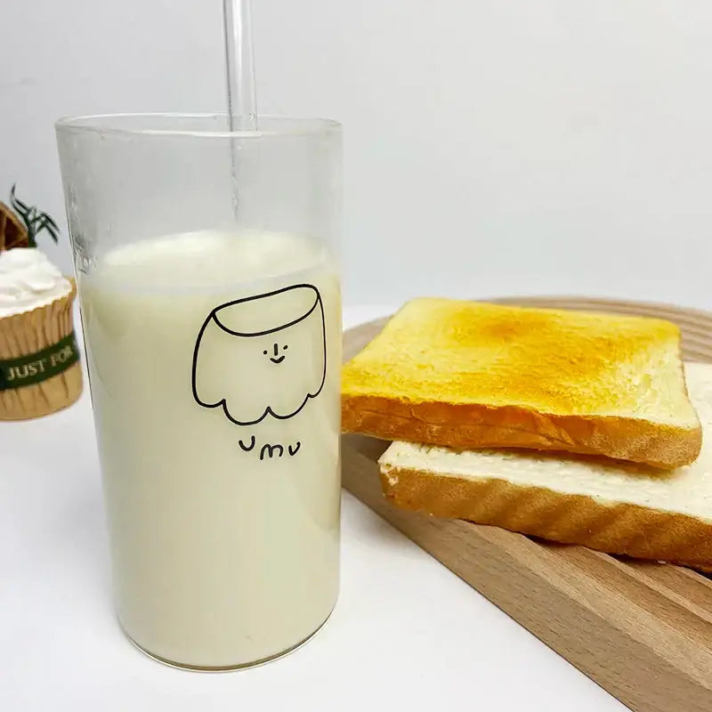 Clear glass cup filled with milk featuring a black line cartoon ghost and jmu text decorbites cartoon glass cup