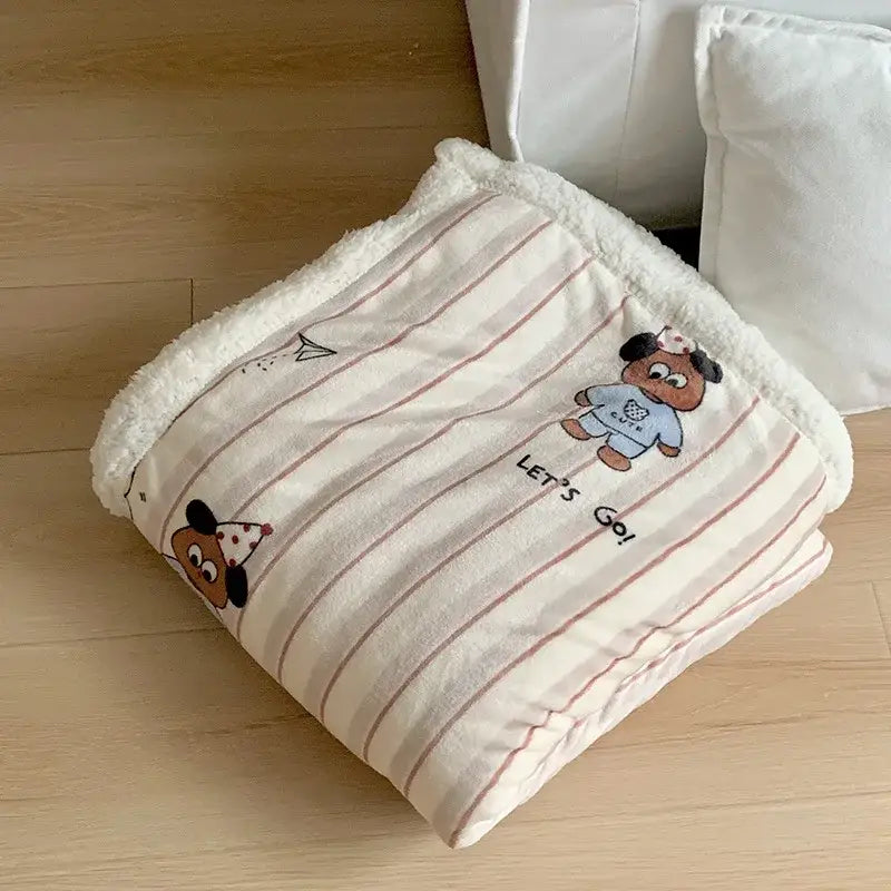 A cozy cartoon lamb wool blanket with cream and pink stripes embroidered with party hat dogs and plush fleece border