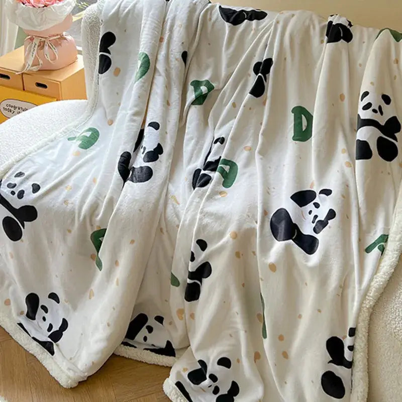 Cream-colored cartoon lamb wool blanket with black and green panda illustrations and gold polka dots bedroom throw