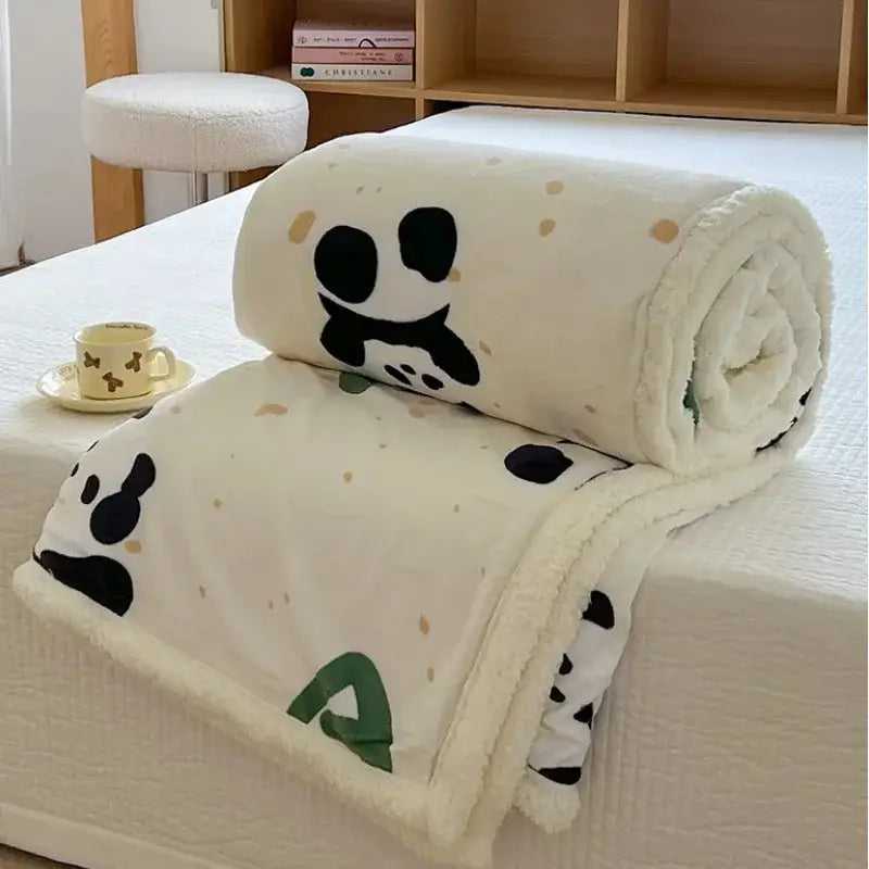 A cozy cream lamb wool blanket with cartoon lamb panda faces black paws beige dots and white fleece border for bedroom use