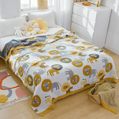 A soft white cartoon lion cotton throw blanket with yellow gray playful lion and elephant pattern and mustard border