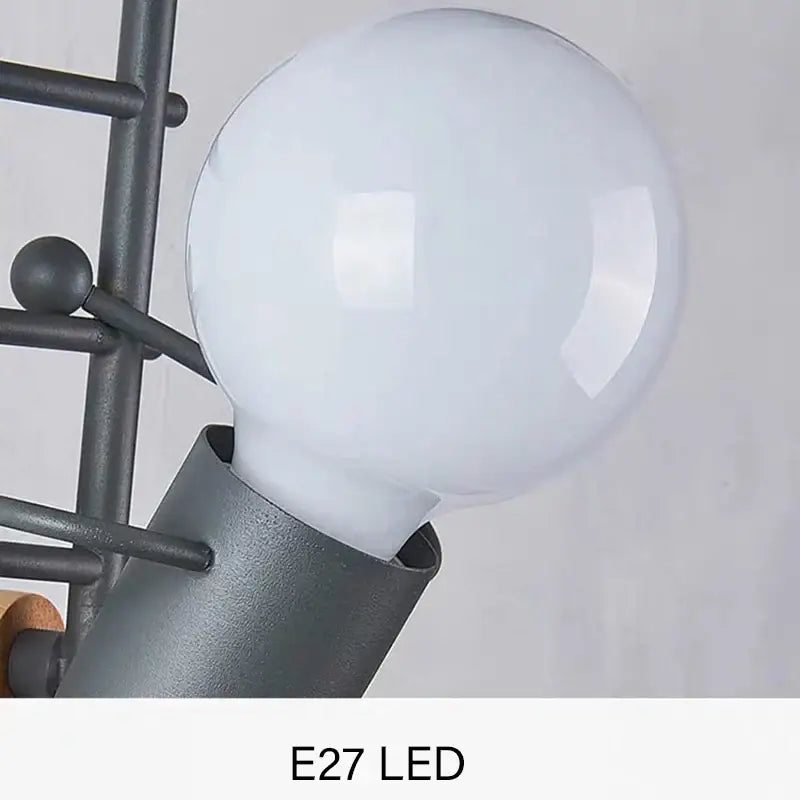 A frosted white spherical led bulb with a matte black metal fixture in a decorbites cartoon matchstick man wall lamp for kids room
