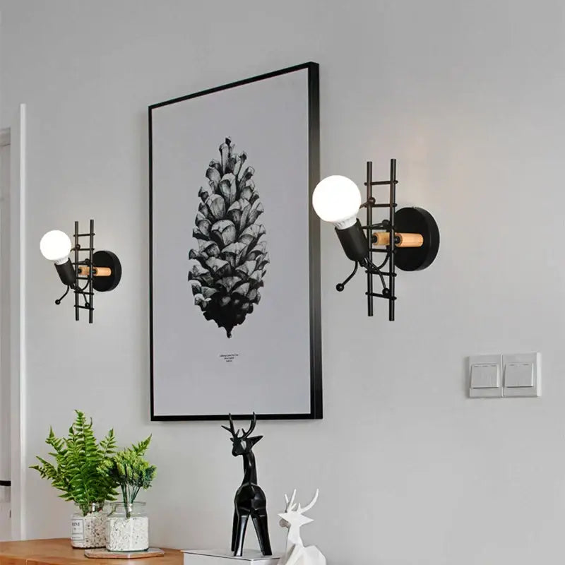 Black metal wall lamp with ladder design and exposed bulb cartoon matchstick man decorbites kids room sconce