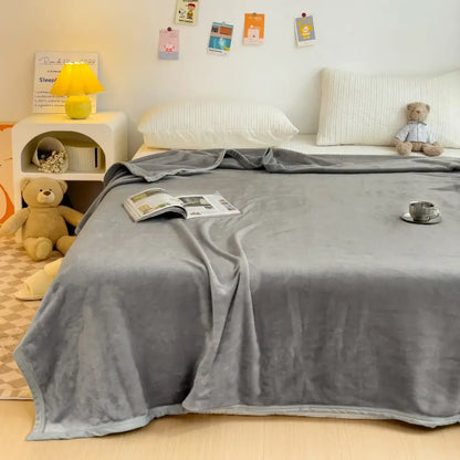Soft gray plush decorbites cartoon milk velvet blanket with subtle sheen draped over bed in white floral bedroom decor