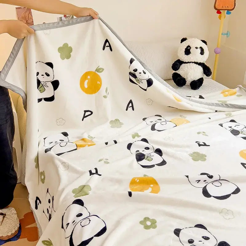 White cartoon milk velvet teddy bear blanket with black and yellow panda illustrations and green floral decorbites cartoon milk
