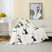 A soft white cartoon panda flannel fleece blanket with black panda silhouettes and pom poms for bedroom decorbites cartoon panda