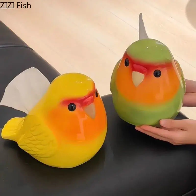Two colorful glossy ceramic cartoon parrot tissue box holders in yellow and green for living room decor by decorbites