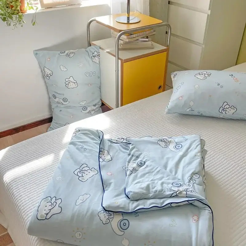 Light blue cartoon patchwork summer cooling blanket with playful bear cloud pattern and navy trim for bedroom decorbites