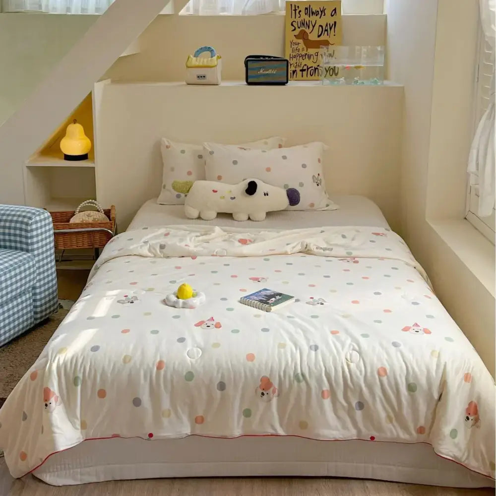 White cartoon patchwork summer cooling blanket with pastel polka dots, embroidered puppy faces, and red piping edges