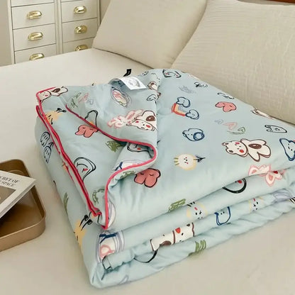 Light blue cartoon patchwork summer cooling blanket with playful animal and heart patterns and pink piping edges by decorbites