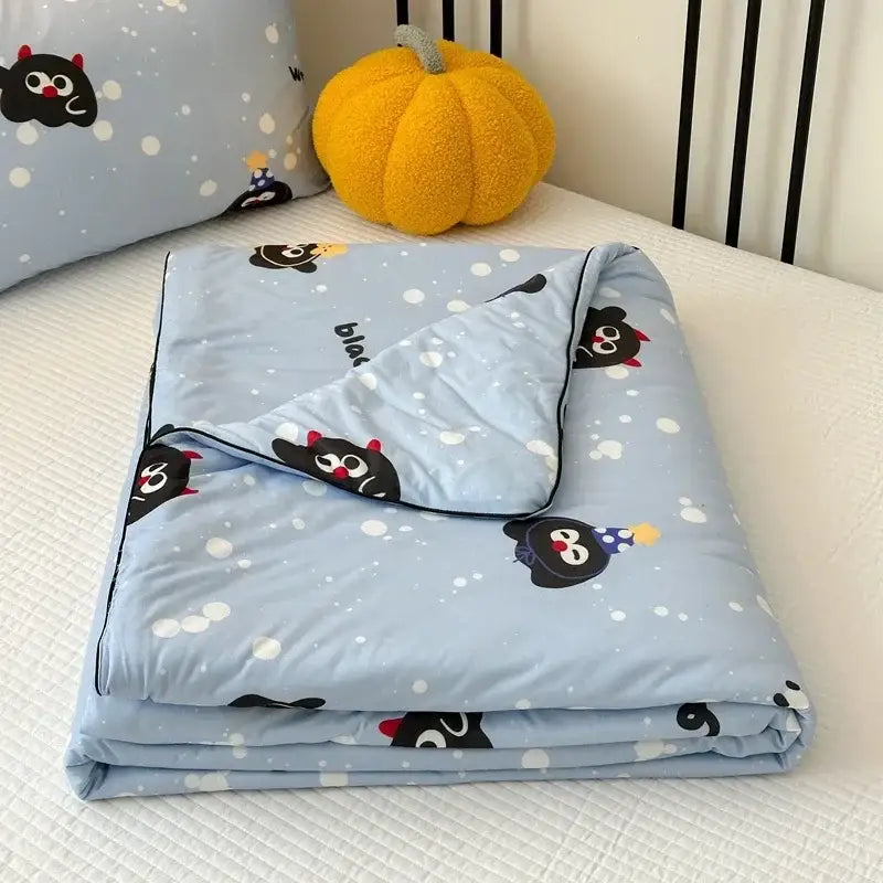 Light blue cartoon patchwork summer blanket with playful black penguins wearing party hats and red horns decorbites cartoon patchwork