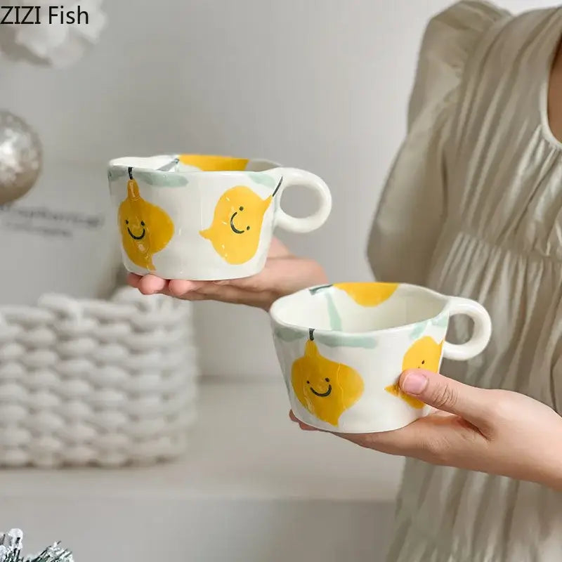 White ceramic mug set with decorbites cartoon pattern featuring cheerful yellow lemons and light green accents