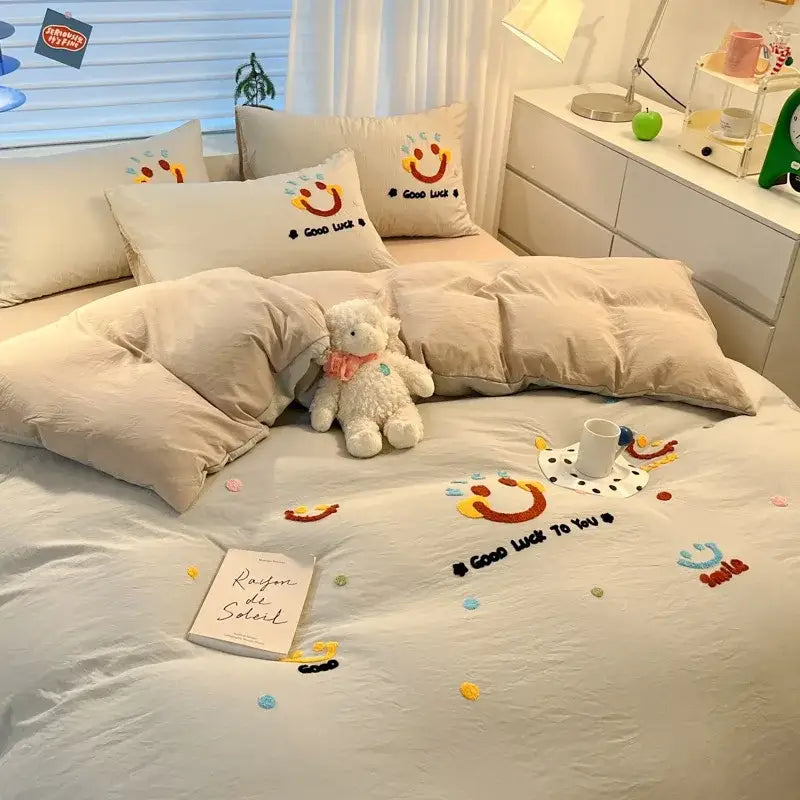 Beige cartoon pattern embroidered bedding sets with cheerful smiley face designs and colorful good luck threadwork decorbites cartoon pattern