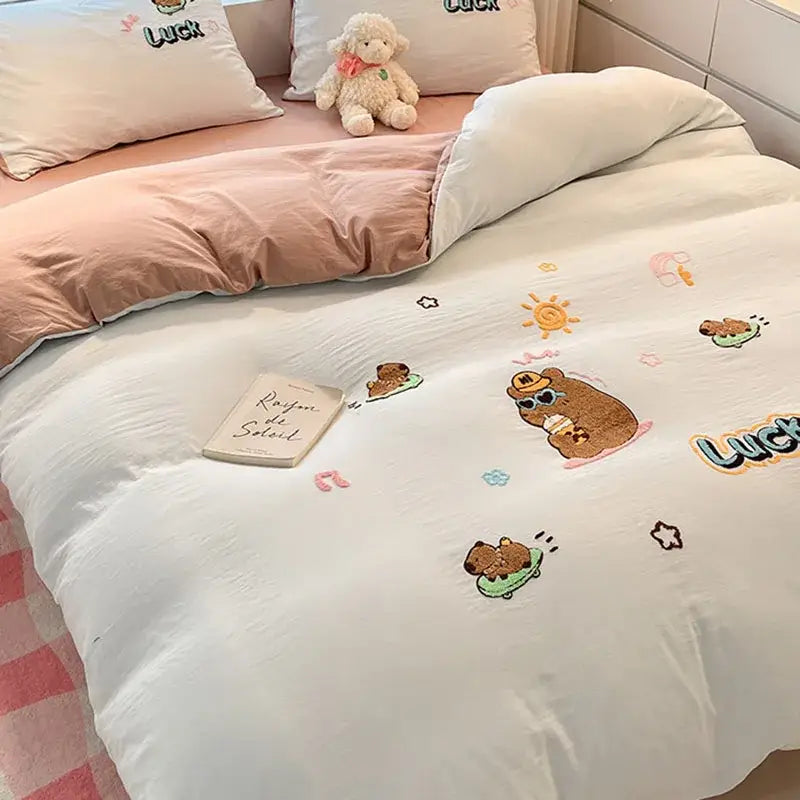 White duvet cover with embroidered brown bear characters and luck text in decorbites cartoon pattern bedding sets