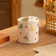 A white ceramic cartoon pattern porcelain toothbrush holder featuring pastel butterflies hearts and flowers for bathroom decor