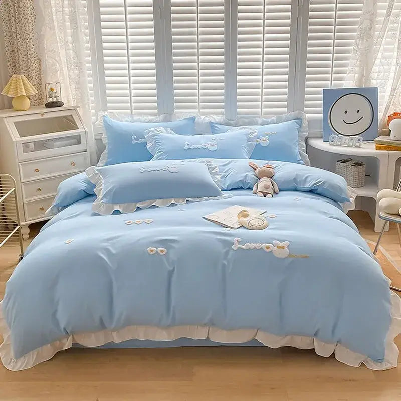 Light blue bedding set with white ruffled trim and cartoon princess embroidered bunny designs by decorbites