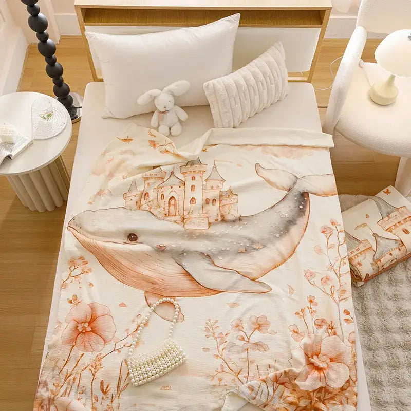 Cream cartoon printed cotton blanket featuring a whimsical whale and castle design with peach floral decorbites print