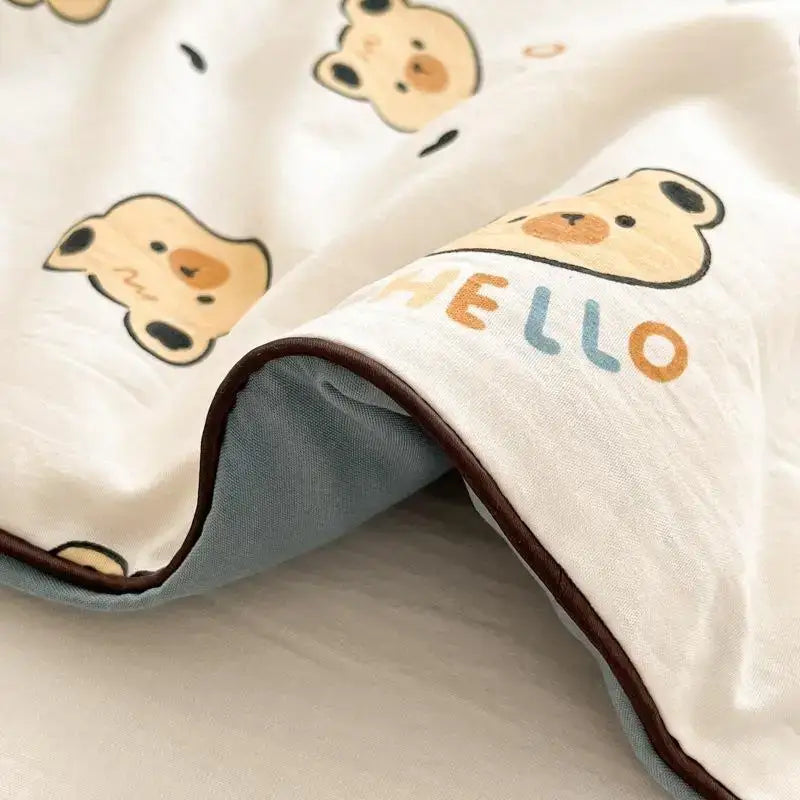 A soft white cooling blanket with beige cartoon bear faces hello print and brown stitched edge decorbites cartoon printed summer
