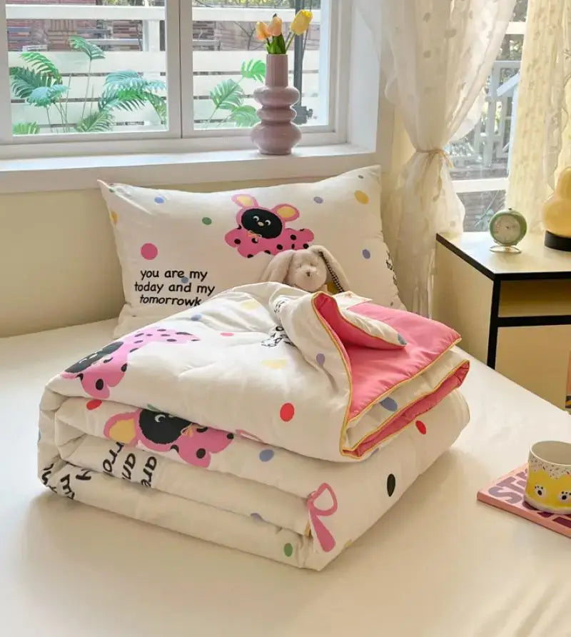 A cozy white cooling blanket with pink and black ladybug cartoon printed patterns and a soft pink inner lining