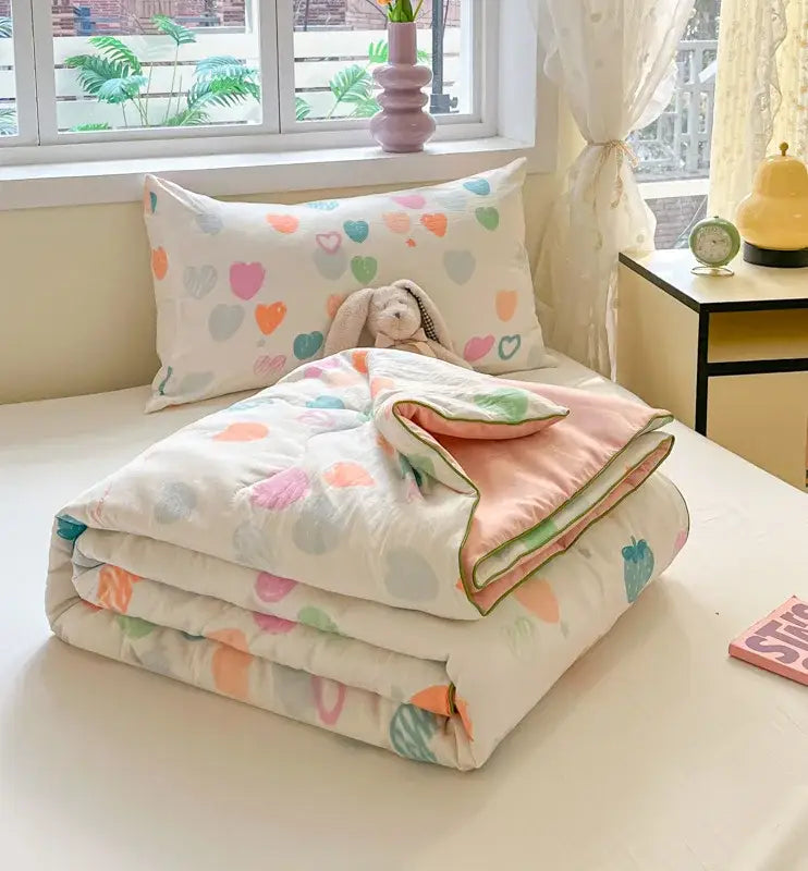 Cozy folded decorbites cartoon printed cooling blanket with pastel hearts and circles on white for summer use