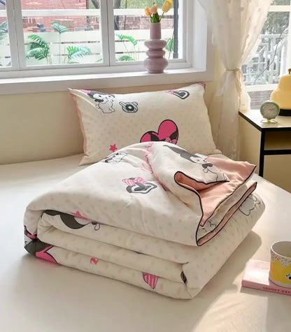 A cream cooling blanket with pink and black minnie mouse patterns and matching pillow for cartoon printed summer use