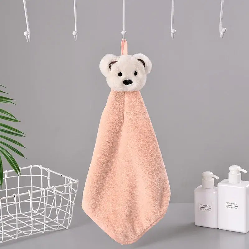 A soft peach-colored coral fleece hand towel with a white bear head and pink loop from decorbites cartoon rabbit collection