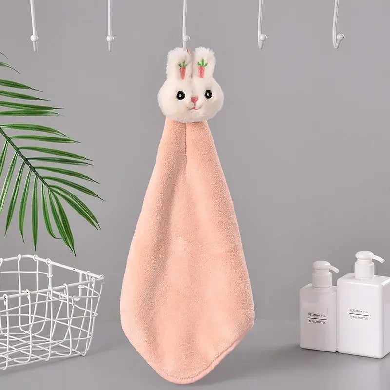 Pink plush coral fleece hand towel with cartoon rabbit design and embroidered carrot ears for quick dry bathroom use