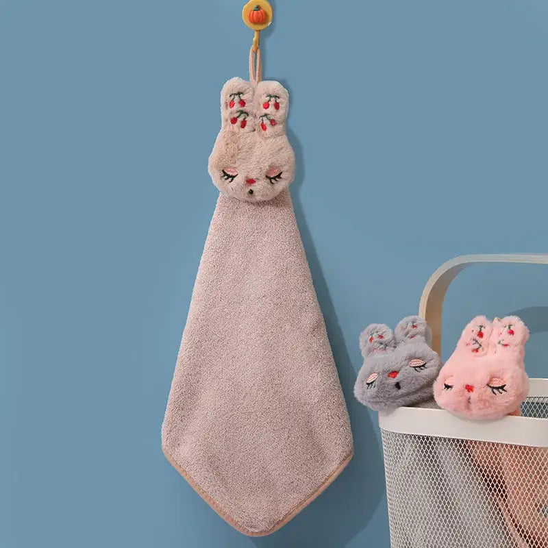 A soft pink coral velvet hand towel featuring plush bunny decorbites cartoon rabbit embroidery with hanging loop