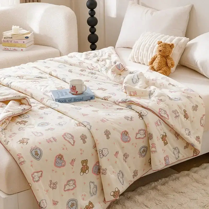 Cream-colored cooling summer blanket with plush texture and pastel teddy bears and hearts for bedroom use