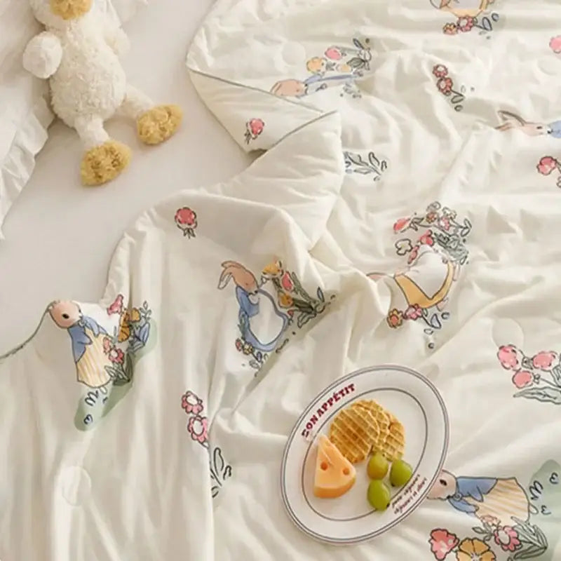 White duvet cover cooling summer blanket with peter rabbit pattern and pastel floral accents for bedroom quilt