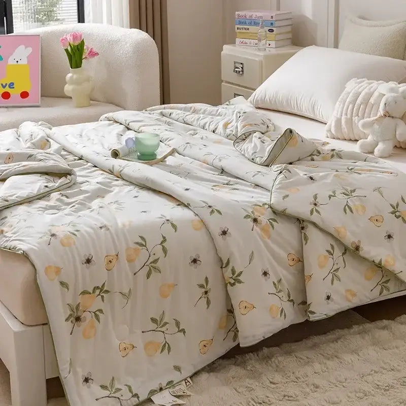 Off white cooling summer blanket quilt with yellow pear pattern and green leaves ideal for summer use