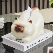 Cream-colored ceramic tissue box shaped like a sleeping cartoon siamese kitten with brown accents for decorbites decor