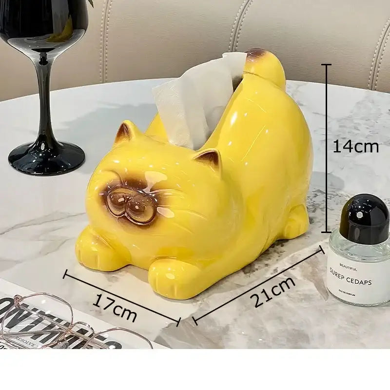 Glossy yellow ceramic tissue box shaped like a chubby cartoon siamese kitten with brown face and tail accents for decorbites decor