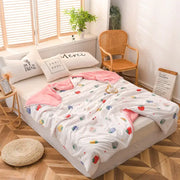White and pink cotton strawberry patterned quilted double blanket with soft plush texture for bedroom use