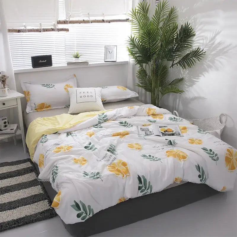 White duvet cover with yellow lemon and green leaf pattern made of soft cotton for cozy comfort quilted double blanket