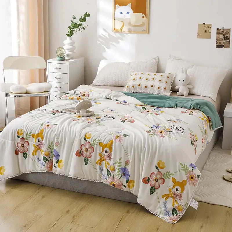 A soft white quilted double blanket with yellow deer pattern colorful flowers and lace trim for bedroom use