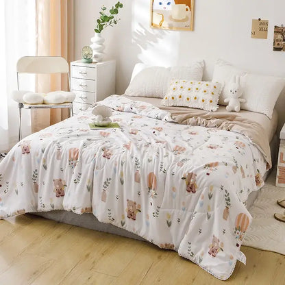 White quilted double blanket with pastel teddy bear and botanical pattern in muted pinks browns and greens