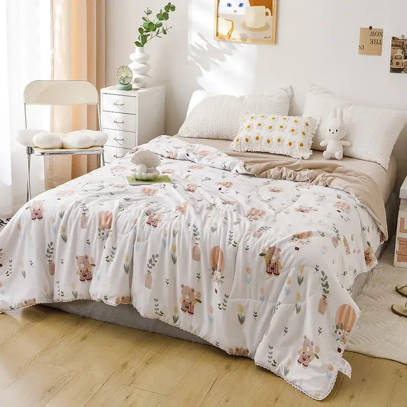 White quilted double blanket with pastel teddy bear and botanical pattern in muted pinks browns and greens