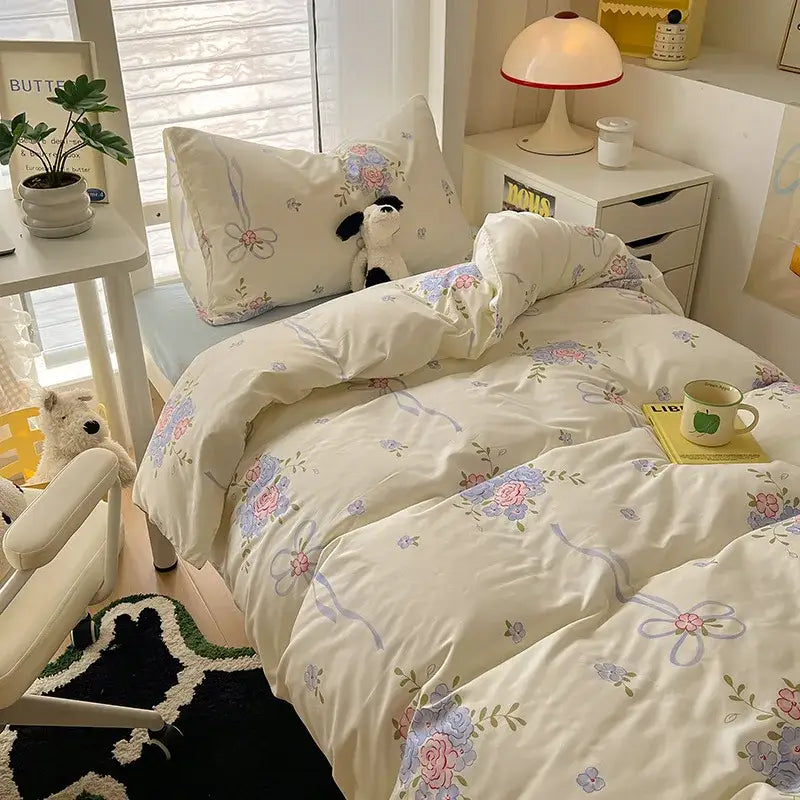 Cream-colored cartoon style cotton bedding sets with pastel pink lavender and blue floral blossoms and ribbons decorbites cartoon style
