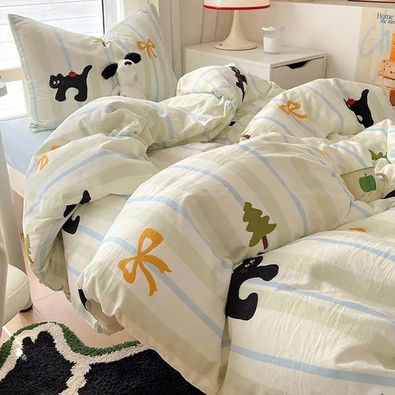A cozy cream and blue cartoon style cotton bedding set with playful black cat, yellow bow, and green tree prints