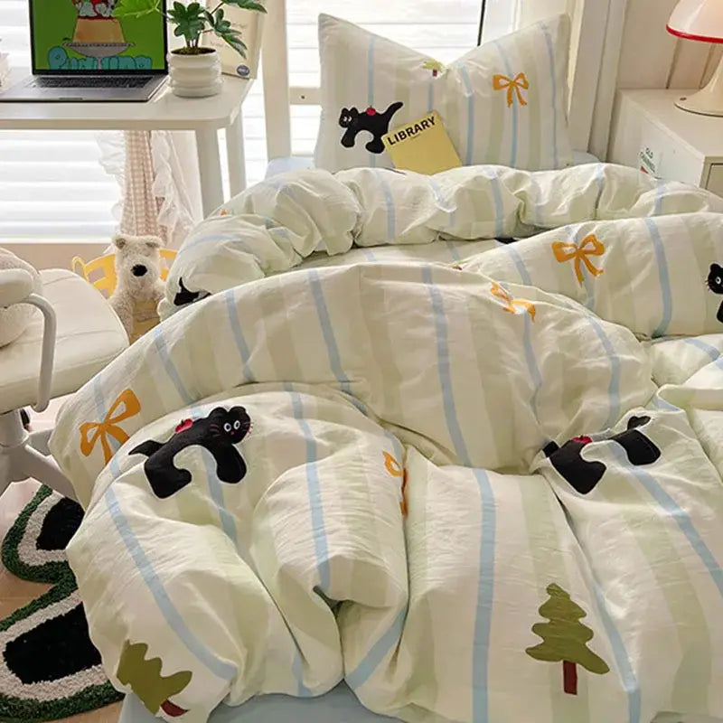 Cozy cream and blue cartoon style cotton bedding sets with black cat appliqués, yellow bows, and green pine tree motifs