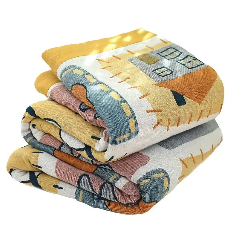 Stacked decorbites cartoon throw blankets with playful house pattern in soft yellow blue and orange on white background