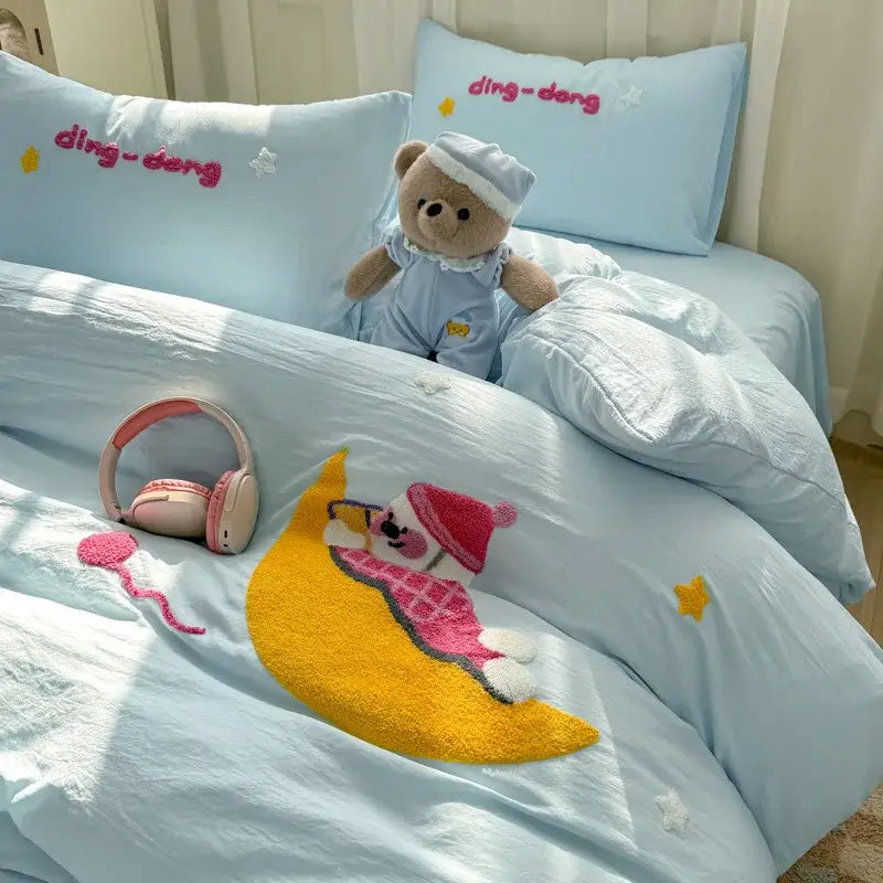 Light blue bedding set with cartoon towel embroidery featuring plush teddy bear in matching pajamas and embroidered pillows