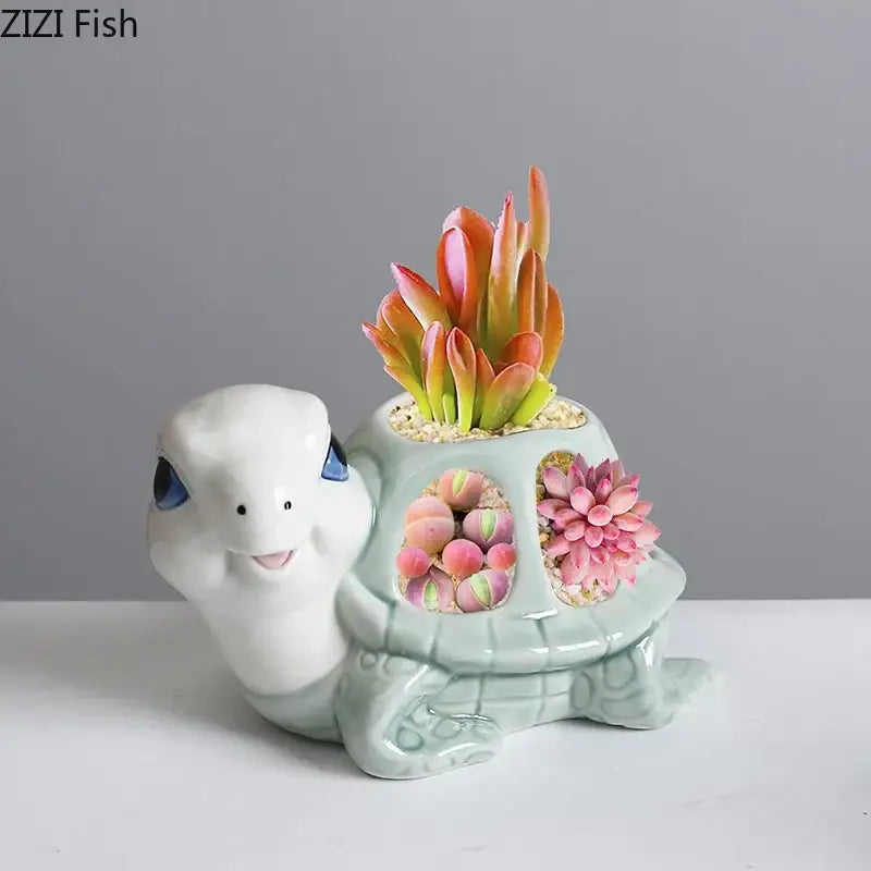 Cute white ceramic cartoon turtle planter with blue eyes and green shell holding colorful succulents decorbites cartoon turtle