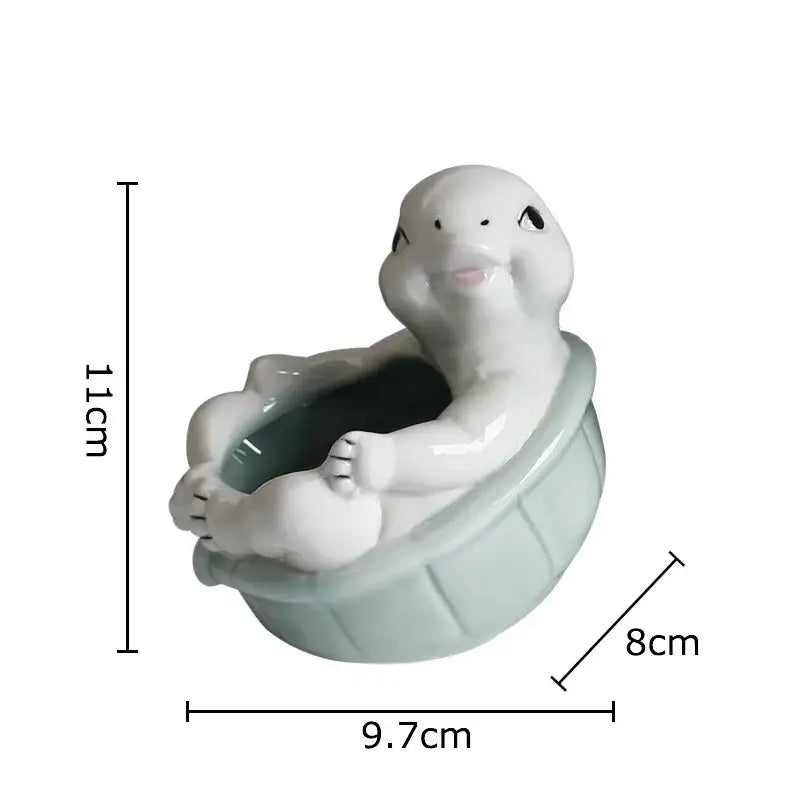 Cartoon turtle ceramic flower vase in glossy white and light green glaze sitting in matching basin planter decorbites cartoon turtle