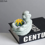 A light green cartoon turtle ceramic flower vase featuring a vibrant yellow and green cactus for living room decor