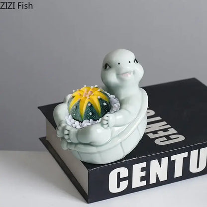 A light green cartoon turtle ceramic flower vase featuring a vibrant yellow and green cactus for living room decor