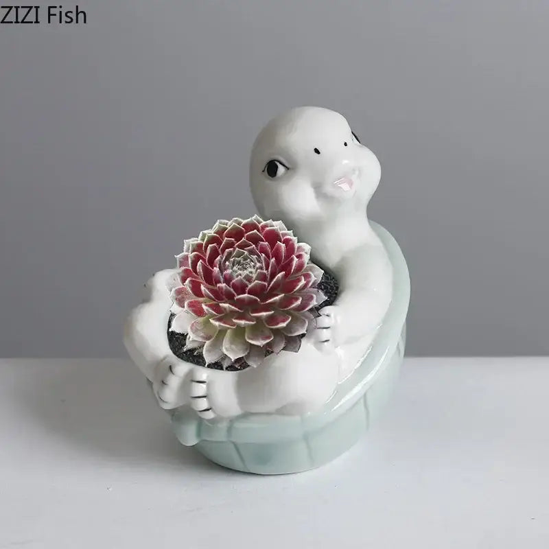 White ceramic cartoon turtle planter with red and green succulent for light green living room decor by decorbites cartoon turtle