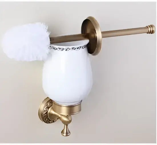 White ceramic toilet brush holder with gold toned carved antique bronze brass ornate metal bracket and handle decorbites