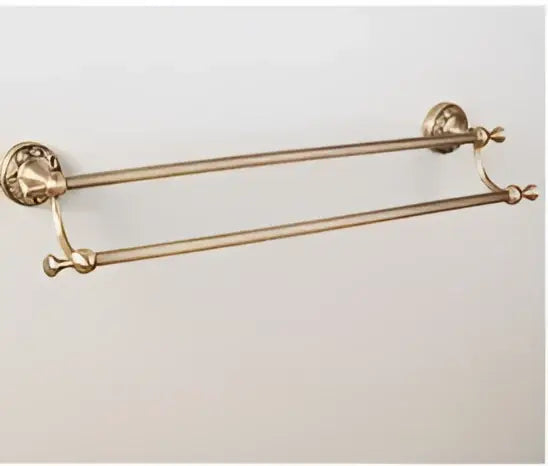 Brass double towel rack with ornate end caps in carved antique bronze brass bathroom hardware set with wall lamps